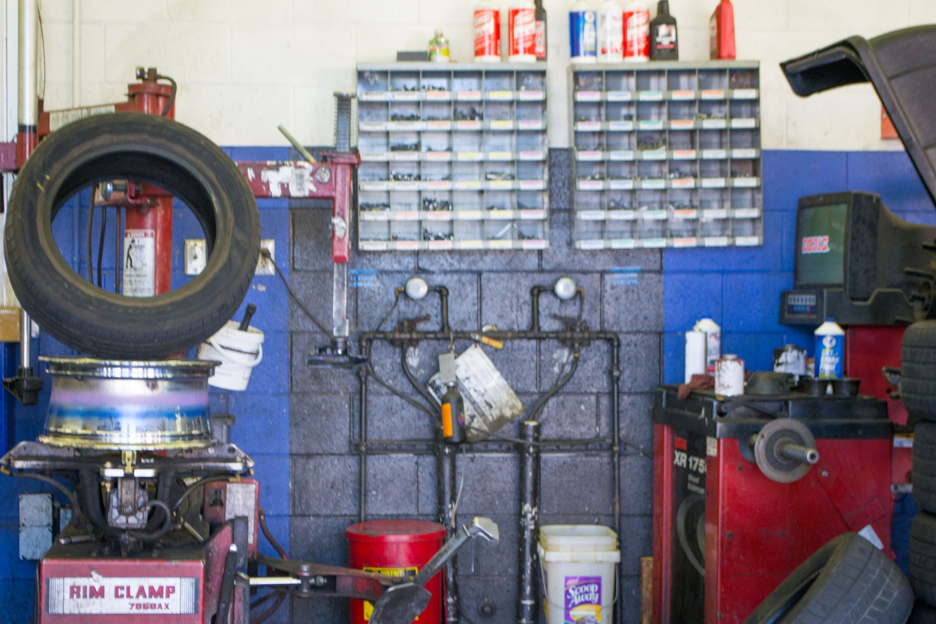 Working bay with a Coats Rim Clamp 7660AX tire changer and a Coats XR 1750 computerized wheel balancer